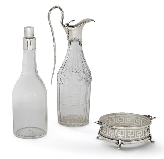 An 18th century silver mounted glass cruet bottle by Hester Bateman, date mark rubbed, designed with elongated handle and hinged lid with stylised shell thumbpiece, the bright-cut engraved collar to cut glass body, 18.3cm high, together with a...