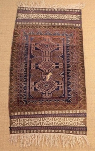 An Antique Caucasian Carpet Rug (A/F) with an 'S' shaped border motif. 30 in x 61½ in (76 cm x 157 cm).