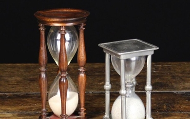 An Antique Pewter Egg Timer; the glass twin-chamber between a square top & base ornamented with wrig
