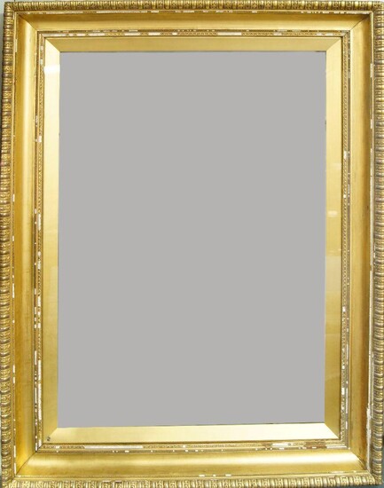 An English Gilded Composition Neo-Classical Style Glazed Frame of Large Proportions, mid-late 19th century, with gilded wedge slip, stiff leaf sight, pearl bead, taenia, plain hollow, the top knull with reel and folded leaf, stiff leaf back edge...