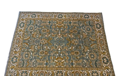 An Indian Carpet the olive green field with an all over desi...