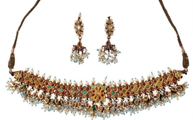 An Indian gold, enamel, ruby, diamond, pearl and turquoise necklace and ear pendants, the necklace composed of a series of cluster links each set with a central turquoise within a border of foil backed cabochon rubies and lasque-cut diamonds, the...