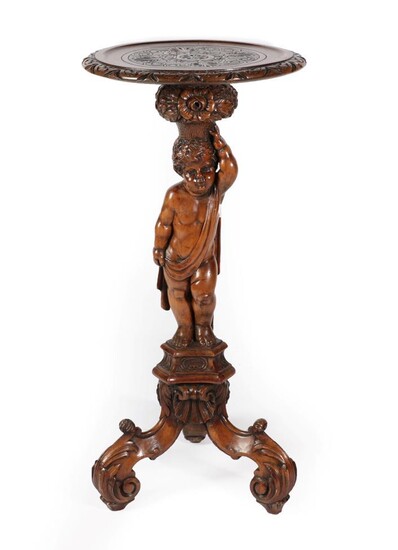 An Italian Carved Walnut Torchere, late 19th century, the circular...