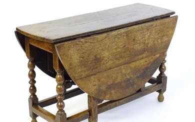 An early 18thC oak drop leaf table of large proportions, the...