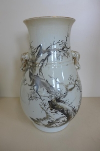 An early 20th century oriental vase with elephant head handl...