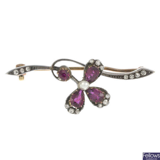 An early 20th century silver and gold, ruby and imitation pearl floral brooch, with diamond accents.