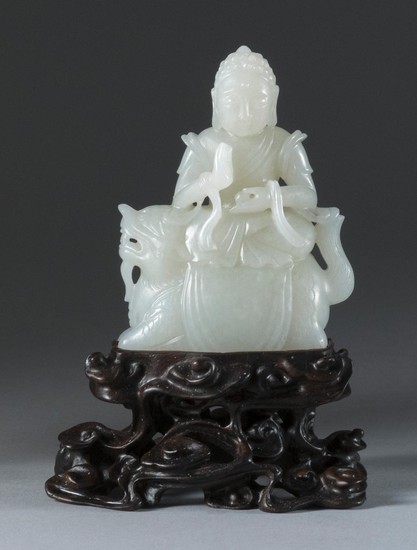 CHINESE WHITE JADE FIGURE In the form of Buddha holding a pearl while balancing on a lion. Height 3.5".