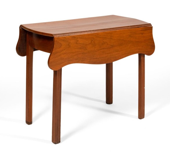 CHIPPENDALE PEMBROKE TABLE In cherry, with shaped drop leaves and block linenfold legs. Height 27.75". Length 19" plus two 9" drop l...