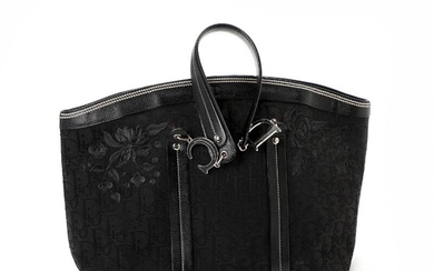 NOT SOLD. Christian Dior: A bag made of black monogram canvas and leather with silver...