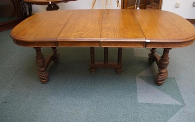 Early 20th century solid medium oak extending dining table...