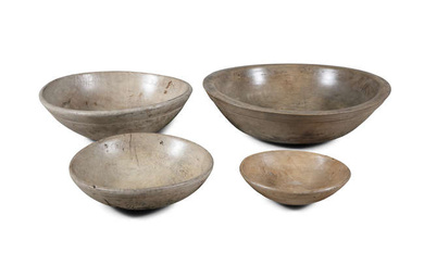FOUR 19TH CENTURY TURNED WOODEN BOWLS, different sizes. The...