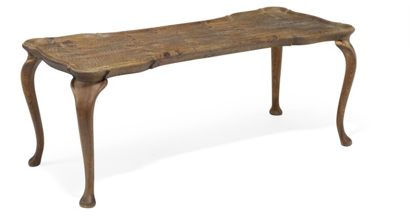Frits Henningsen, attributed: Coffee table of carved, patinated oak with cabriole legs. Curvy top with raised edges.
