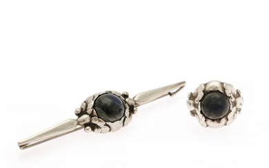 Georg Jensen: A jewellery collection comprising a ring and a brooch each set with a cabochon labradorite, mounted in silver. Size 54. L. 7.2 cm. (2)