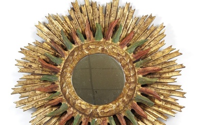 Important miroir soleil en bois doré et peint, formé de deux parties superposées. Travail du...