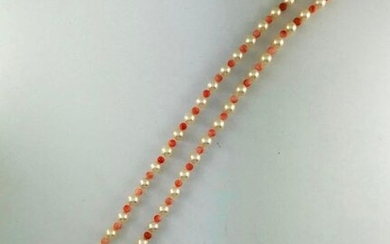 Long necklace of cultured pearls of approx. 6.5 mm dia. alternating with pink coral pearls