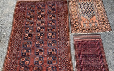 SOLD. Three semiantique Oriental rugs. Afghan rug and two Persian Belouch rugs. (3) – Bruun...
