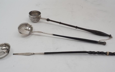Three toddy/punch ladles, comprising; one with twisted baleen handle, the white metal bowl with 1787 shilling to centre (bowl detached), 39cm long; another with turned wooden handle and deep white metal bowl with 1783 shilling to centre, 35.5cm...