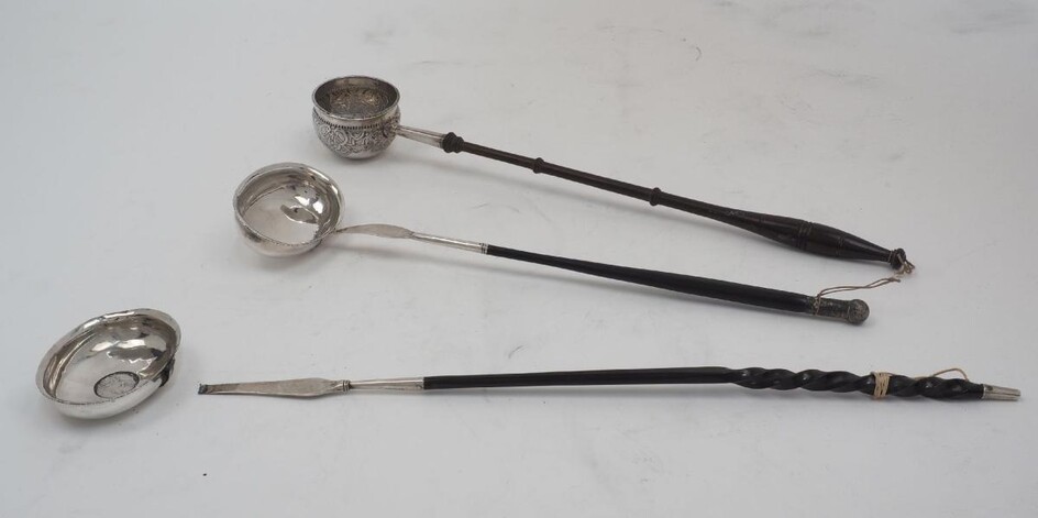 Three toddy/punch ladles, comprising; one with twisted baleen handle, the white metal bowl with 1787 shilling to centre (bowl detached), 39cm long; another with turned wooden handle and deep white metal bowl with 1783 shilling to centre, 35.5cm...