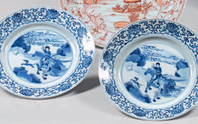 Two china plates. Kangxi (1662-1722), six-character mark, Chenghua, in blue under cover in a double circle. With blue-white decoration, in the center of riders hunting in a landscape in a medallion with circles, the wing of arabesques with lotus...