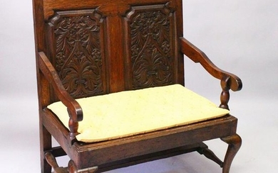AN 18TH CENTURY AND LATER OAK SETTLE, with carved