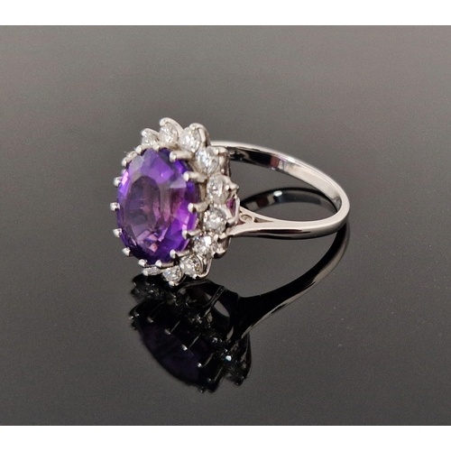 18ct gold, amethyst and diamond cluster ring, the oval ameth...