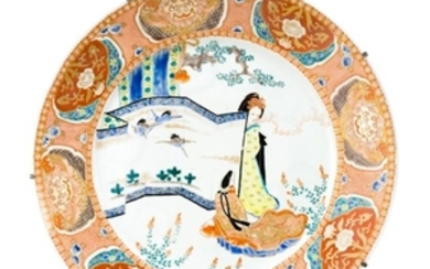 IMARI PORCELAIN CHARGER Depicting two ladies with a crane-decorated screen surrounded by a shishi and passionflower border. Undersid...