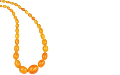 An amber necklace The graduated single-strand of oblong...