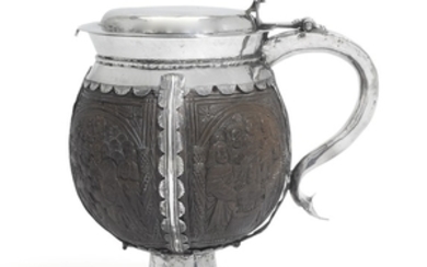 An English silver-mounted carved coconut tankard, the carving probably North German, early 16th century, the unmarked mounts possibly slightly later