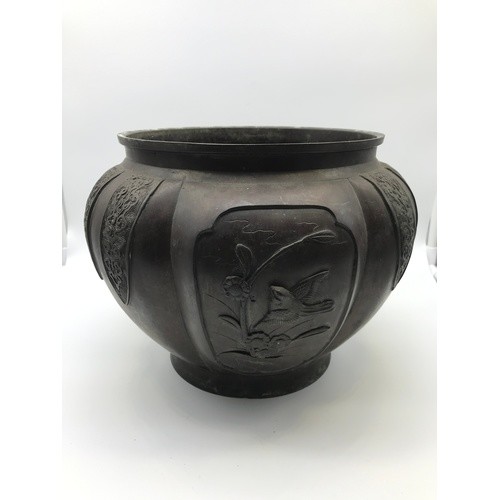 A 19th century Chinese Bronze planter. Detailed with raised ...