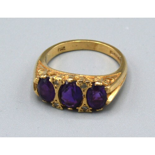 A 9ct. Gold Dress Ring set three amethysts interspaced with ...