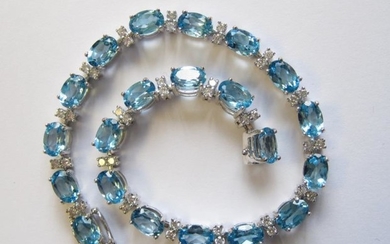 A Blue Topaz and Diamond Line Bracelet claw-set twenty...