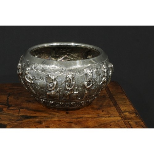 A Burmese silver circular bowl, interestingly repousse chase...