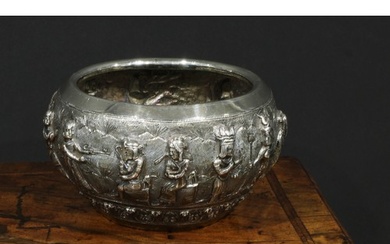 A Burmese silver circular bowl, interestingly repousse chase...