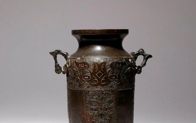 A CHINESE ARCHAISTIC BRONZE VASE MING DYNASTY The tall cylindrical...