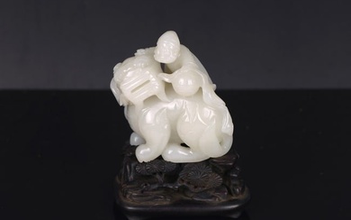 A CHINESE WHITE JADE 'FOREIGNER TAMING LION' CARVING