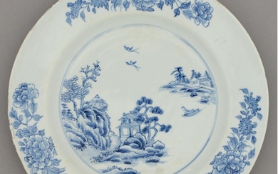 A Chinese blue and white dish, 18th c, painted with a river ...