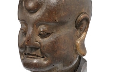 A Chinese carved wooden head of a Louhan. Ming 17th century. H. 23 cm. Wooden stand incl.
