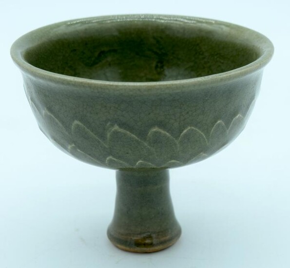 A Chinese celadon stem cup with embossed carp and