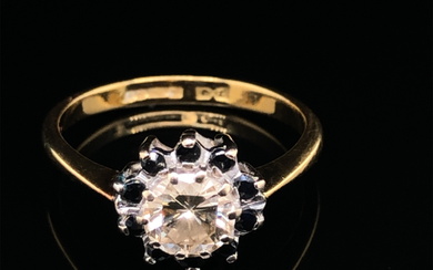 A DIAMOND AND SAPPHIRE ROUND CLUSTER RING. THE CENTRE DIAMOND A ROUND BRILLIANT CUT, ASSESSED