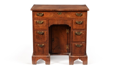 A George I walnut and feather banded kneehole desk