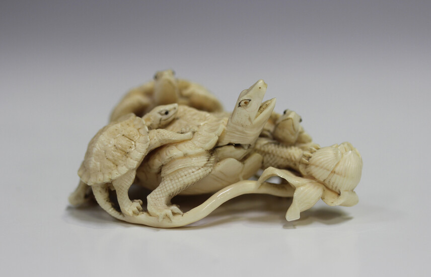 A Japanese carved ivory okimono figure group of tortoises, Meiji period, finely modelled with a larg