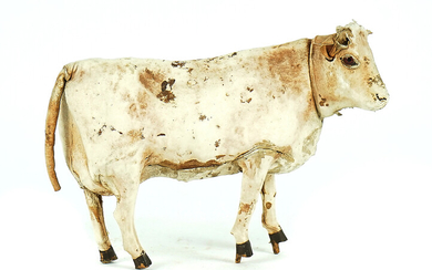 A LEATHER COVERED TOY COW