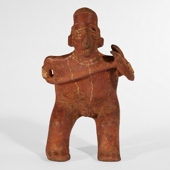 A Nayarit pottery figure of a standing male musician