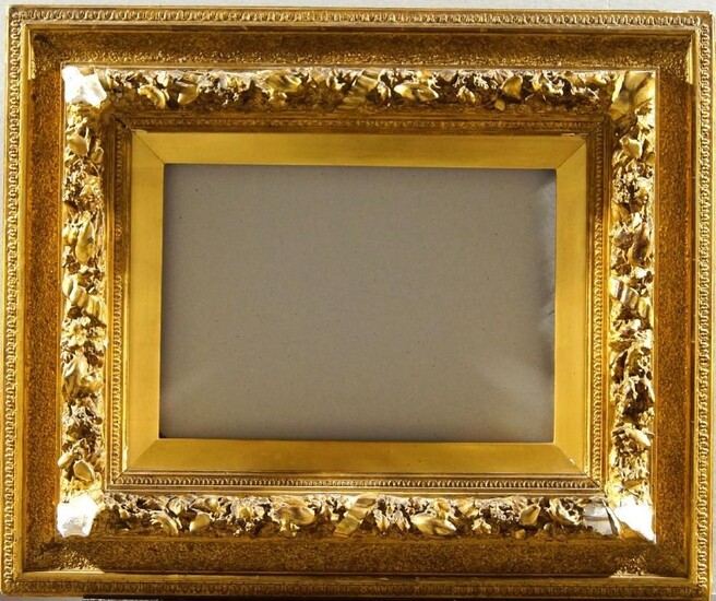 A Pair of Gilded Composition Italian Bolognese Style Frames, mid-late 19th century, with wedge slip, cavetto sight, lambs tongue, the centre and corner tied torus with leaf and berry in high relief, sanded frieze, taenia and stiff leaf back edge...