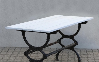 A Swedish garden table with cast iron lower part and painted top....