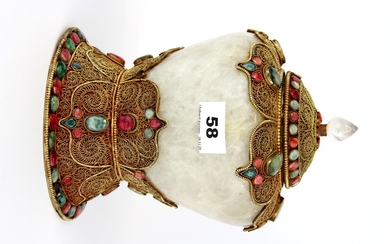 A Tibetan rock crystal and gilt filigree mounted offering jar and cover, inset with red and green rubies, H. 23.5cm.