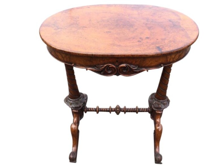 A Victorian walnut sewing table, the oval hinged top...