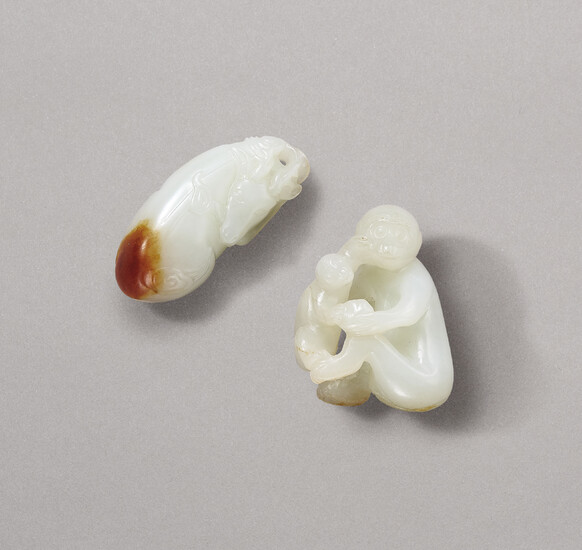 A WHITE AND RUSSET JADE ‘DEER’ PENDANT AND A WHITE JADE MONKEY GROUP, QING DYNASTY (1644-1911)
