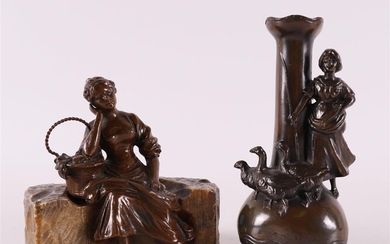 (-), A brown patinated white metal seated woman...