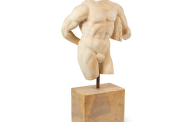 A carved marble torso of a male on a marble pedestal